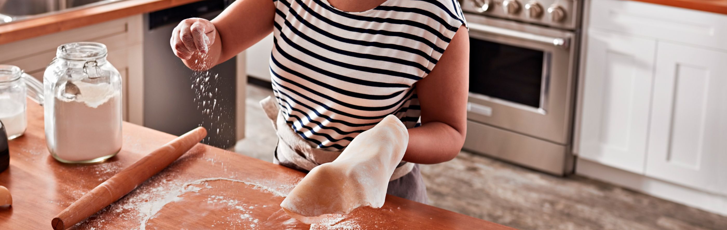 Person rolling out dough on a countertop