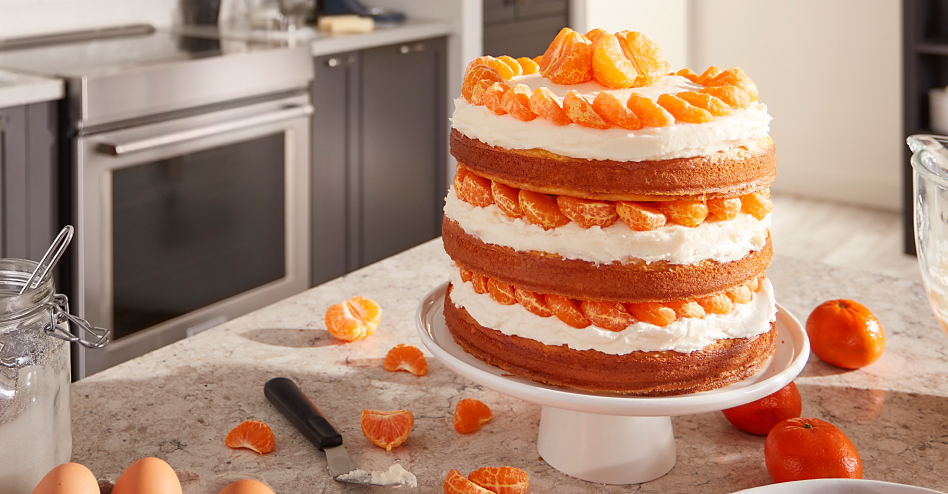 Three layer citrus cake on a cake stand