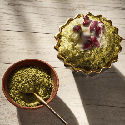 Korean shaved ice dessert topped with red beans and matcha powder