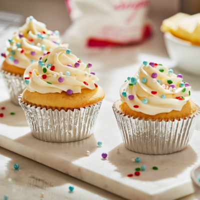 Cupcakes frosted with buttercream frosting and decorative sprinkles