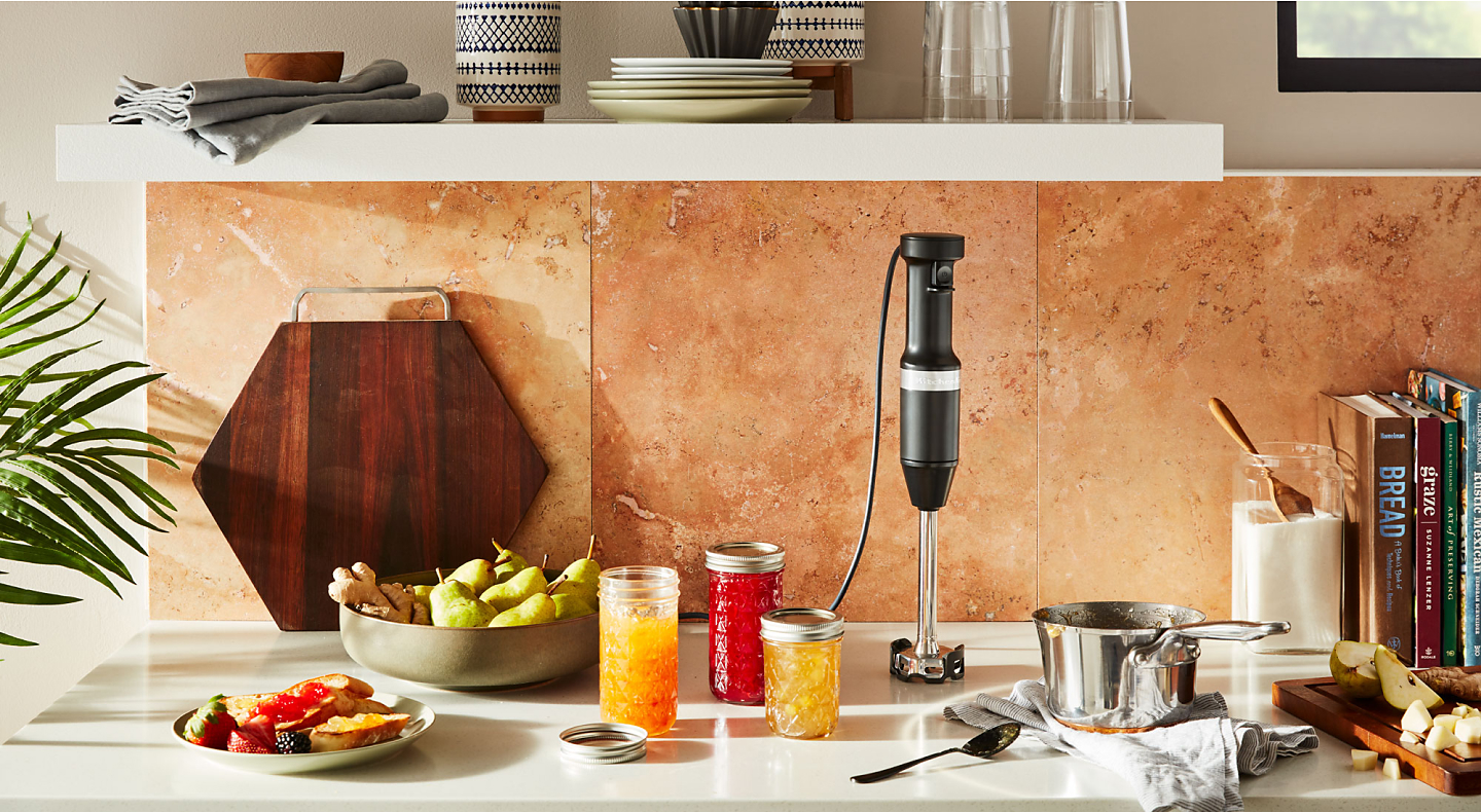 KitchenAid® hand blender on countertop with homemade jams