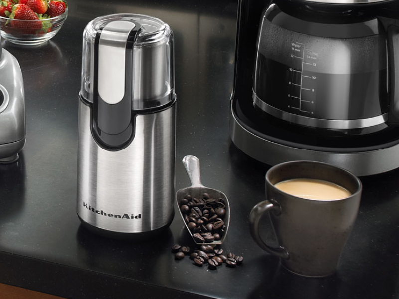 KitchenAid® coffee blade grinder and cup of coffee