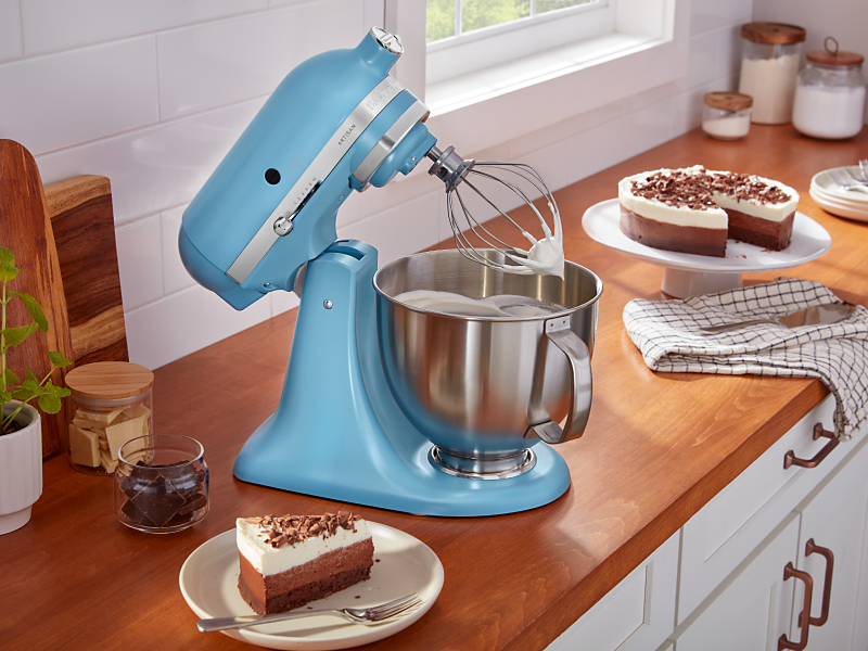 A KitchenAid® stand mixer whipping egg whites into meringue for a pie in a modern kitchen.