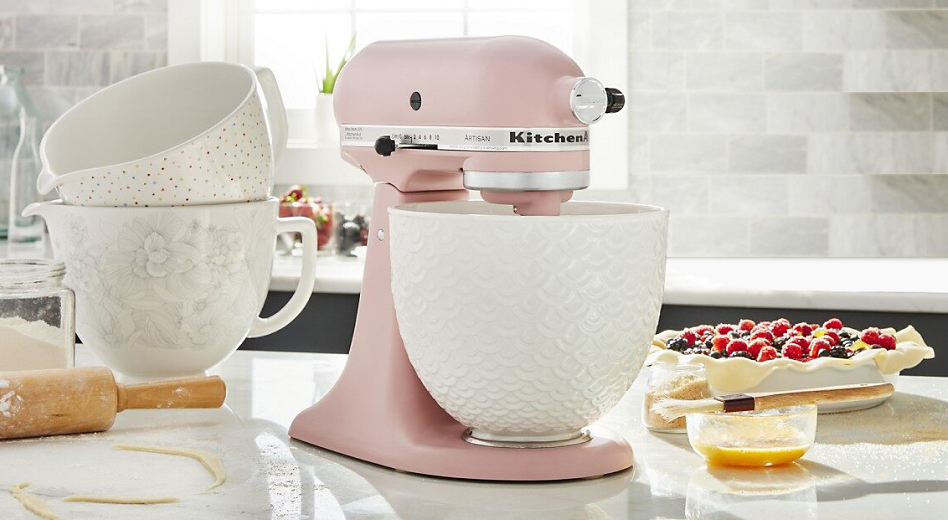 Pink stand mixer with white mermaid lace bowl and two more bowls stacked in the background