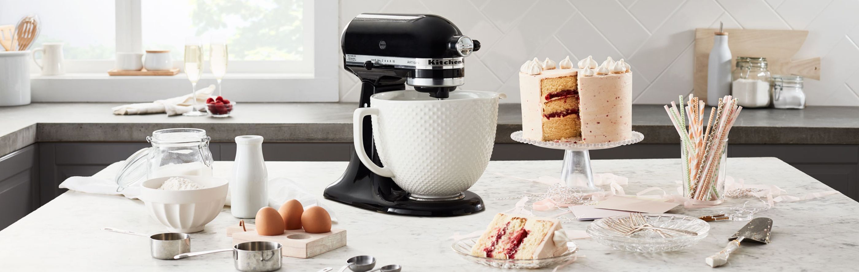 Black KitchenAid® stand mixer on counter with baking ingredients