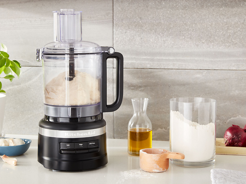 KitchenAid® food processor on counter next to ingredients