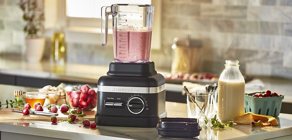 Black blender making a smoothie on counter Black blender making a smoothie on counter