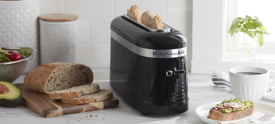 Black one-slot toaster with slices of bread Black one-slot toaster with slices of bread