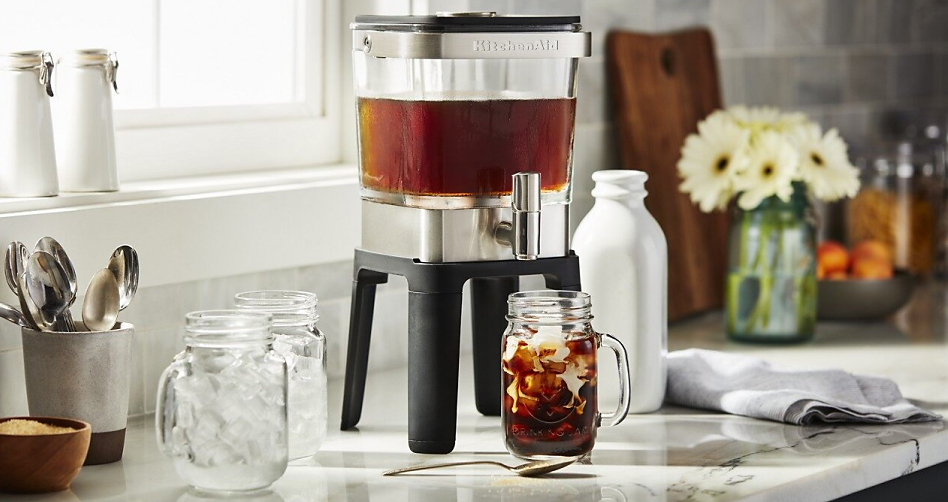 Cold brew coffee maker with mugs of iced coffee