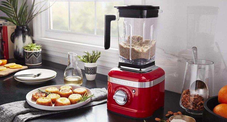 Red blender making almond flour on counter Red blender making almond flour on counter