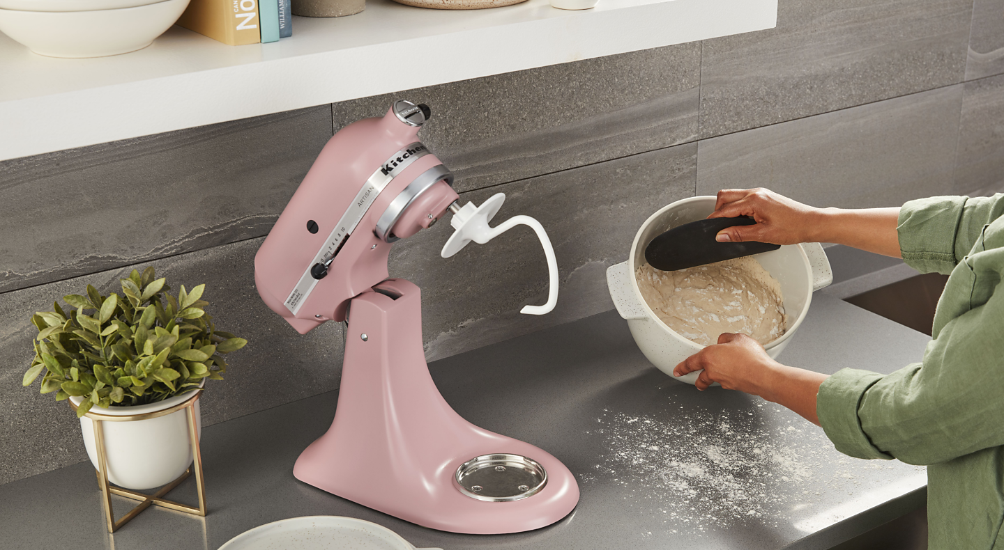 Person using pink tilt-head KitchenAid® stand mixer