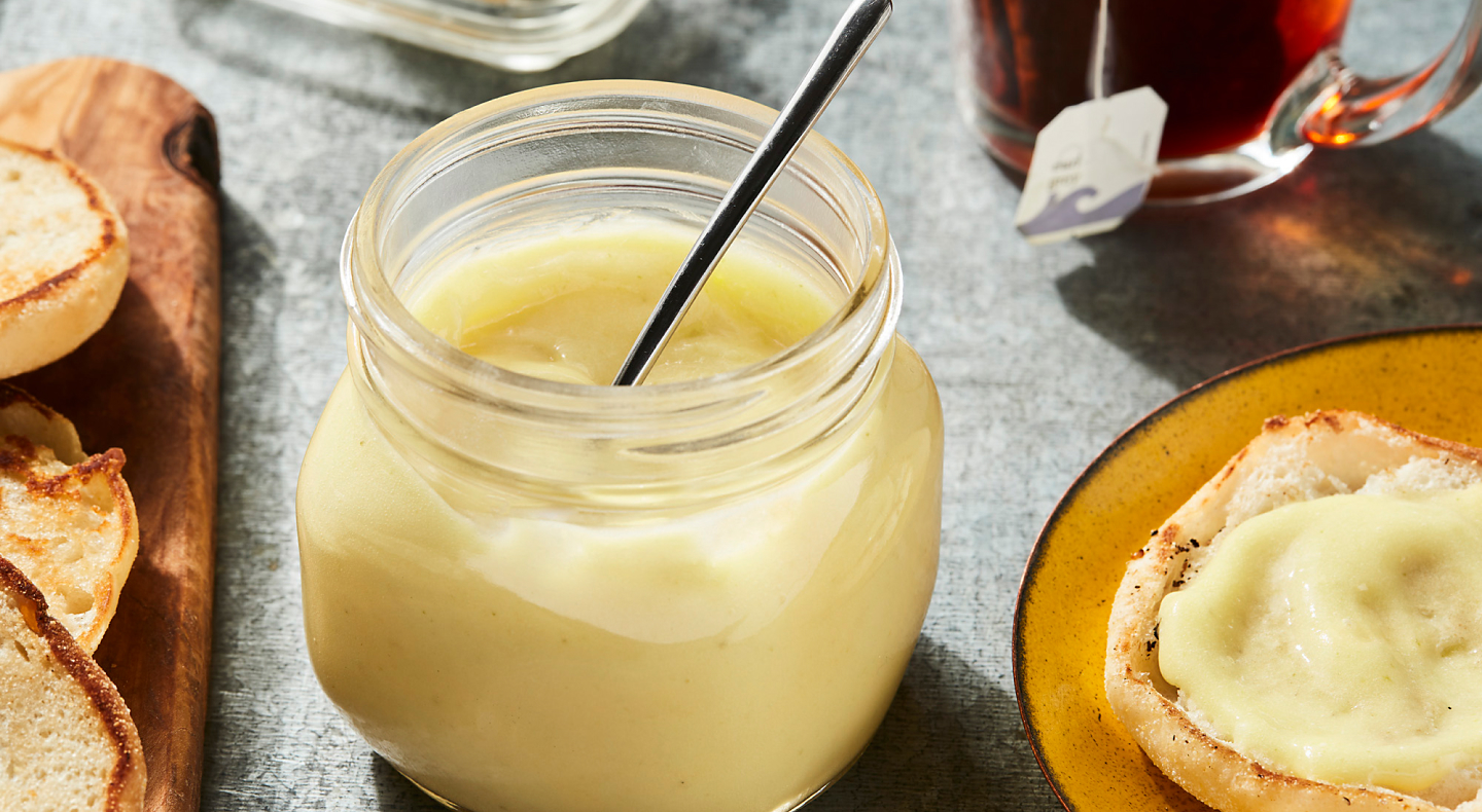 Jar of lemon curd with muffins