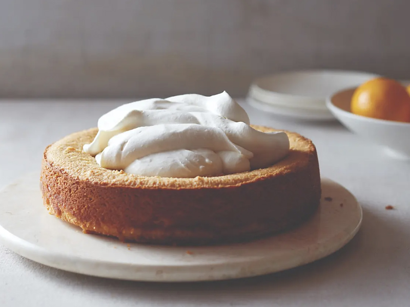 Pastry with whipped topping on white plate