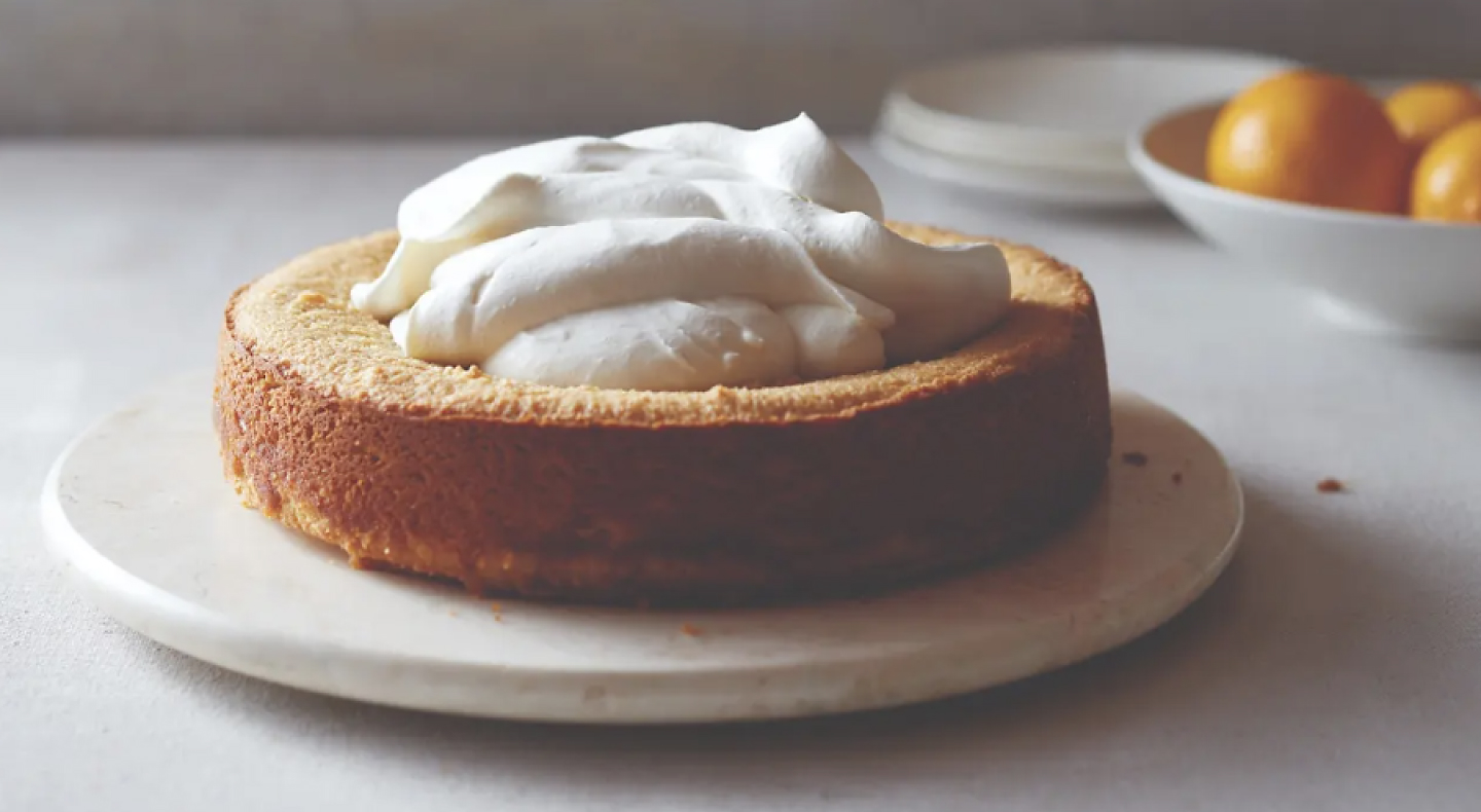 Pastry with whipped topping on white plate
