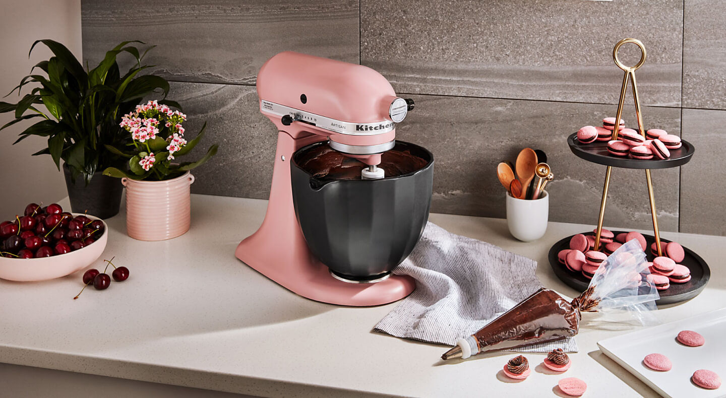 KitchenAid® stand mixer with black bowl next to homemade macaroons