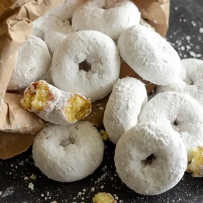 Medium-sized donuts covered in powdered sugar