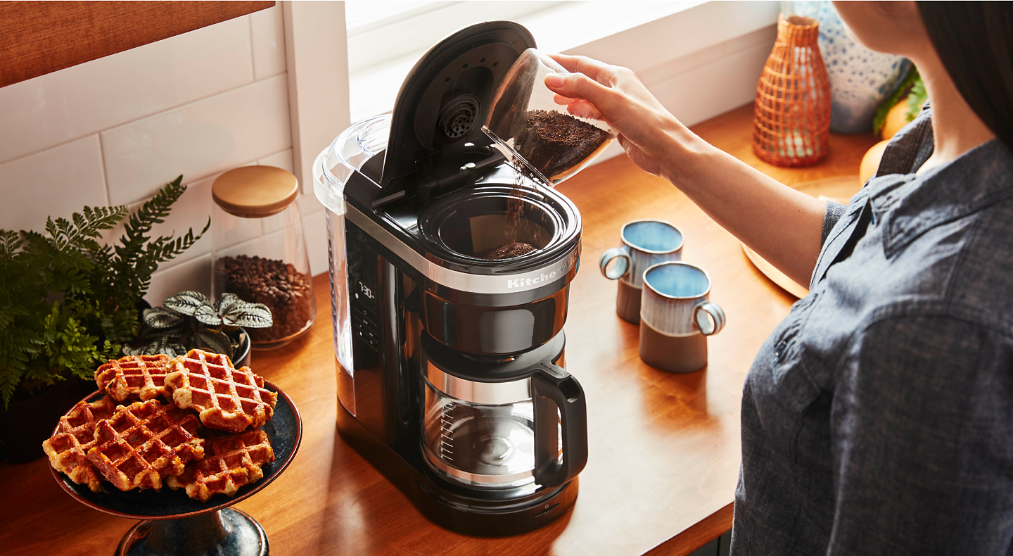 Person making coffee with a KitchenAid® Drip Coffee Maker