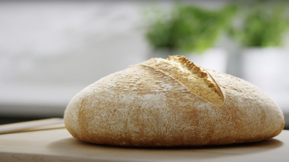 A golden brown loaf of sourdough bread.