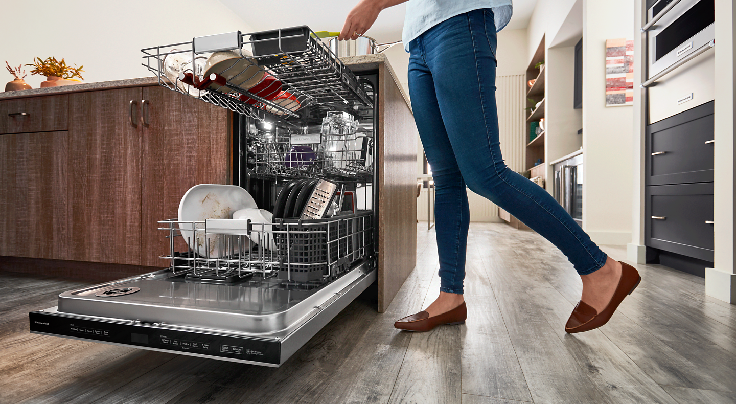 Person loading a dishwasher