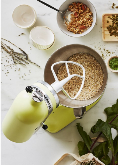 Birds-eye view of lime green KitchenAid® stand mixer with bowl full of crumb ingredients