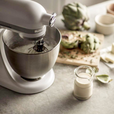 White KitchenAid® stand mixer full of ingredients 