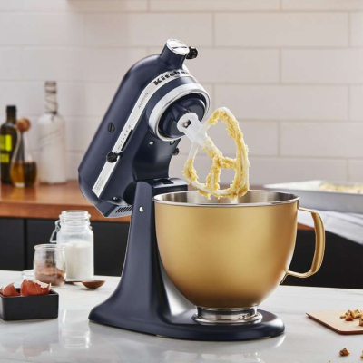 Black KitchenAid® stand mixer with gold stand mixer bowl full of batter