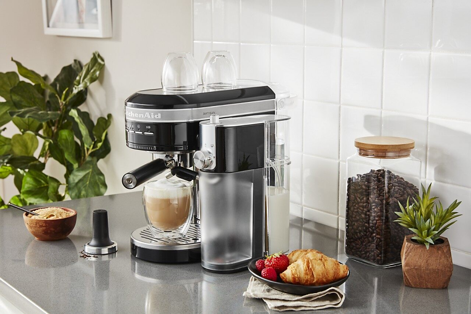 Black semi-automatic type of espresso machine with cappuccino on counter