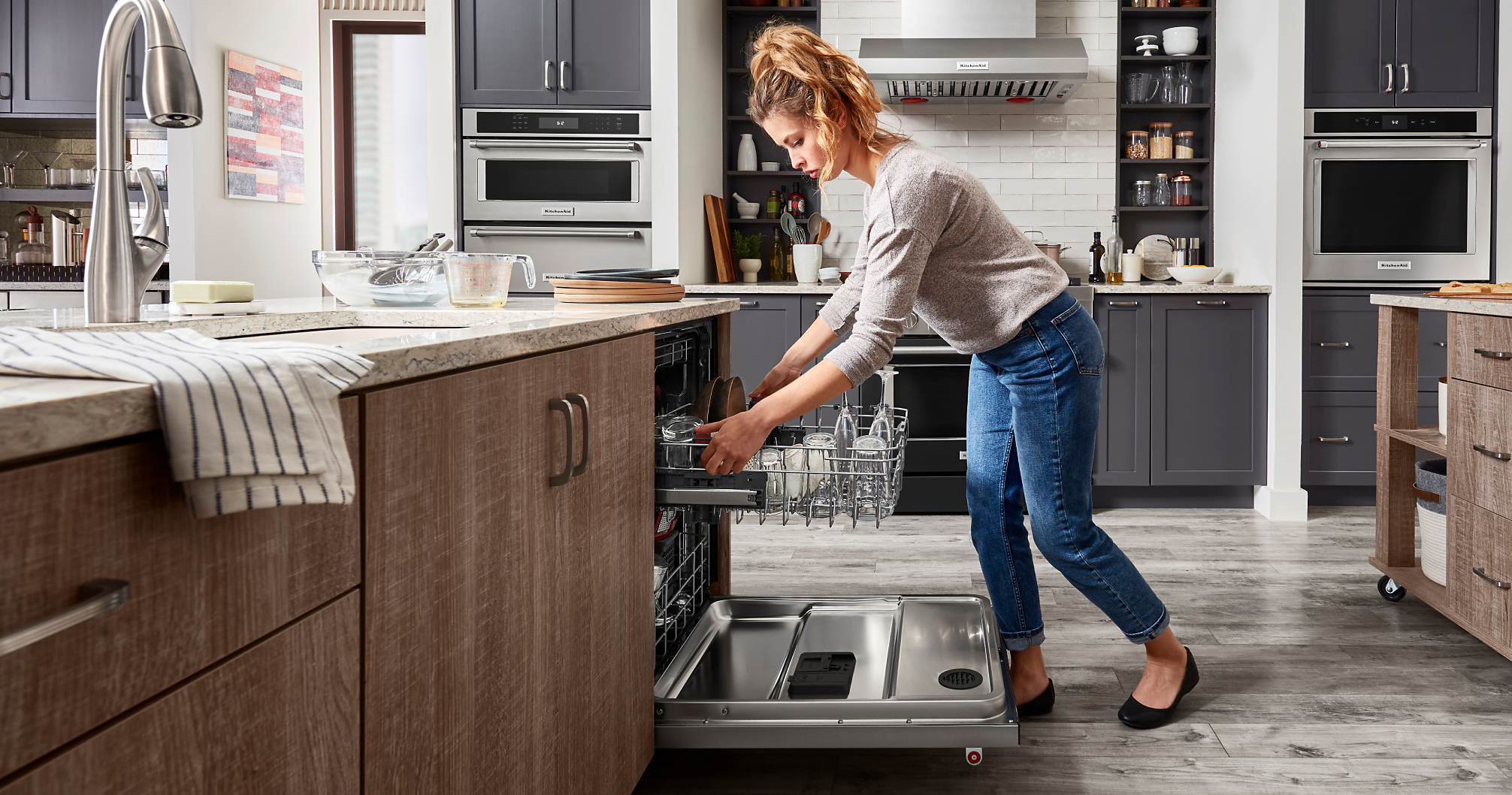 Woman lowering rack in dishwasher