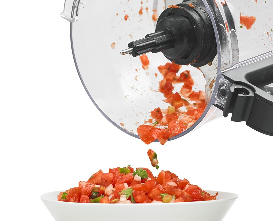Salsa being transferred from food processor work bowl to a serving bowl