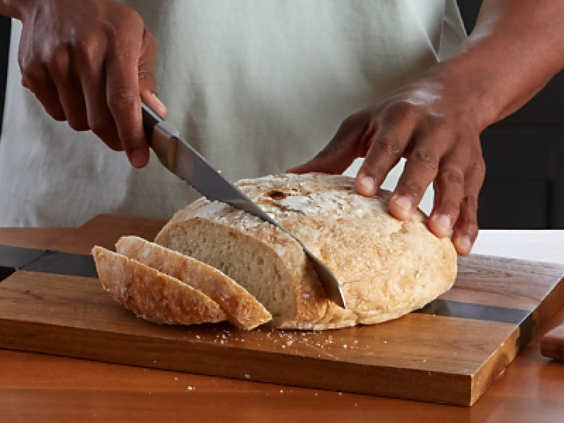 Person slicing bread