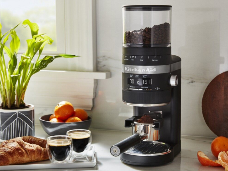 KitchenAid® Burr Coffee Grinder filled with coffee beans on counter