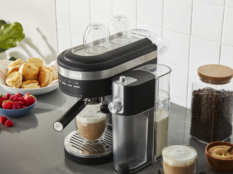 KitchenAid® espresso machine with the Milk Frother Attachment on counter with breakfast foods and latte