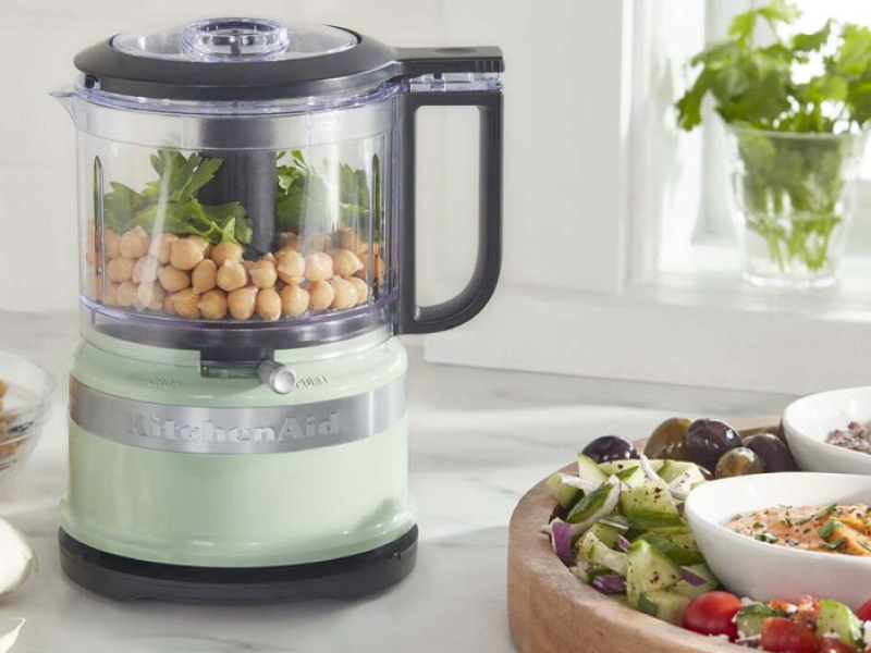 Light green KitchenAid® food chopper filled with chickpeas and greens