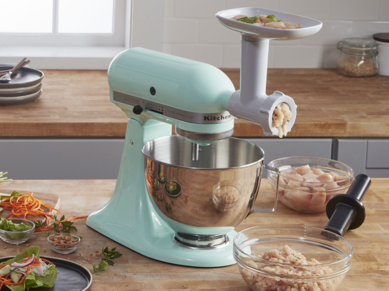 Mint green KitchenAid® stand mixer with the Food Grinder Attachment grinding chicken