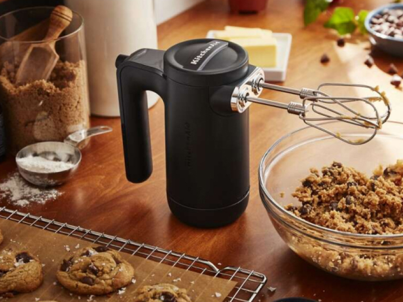 Matte black KitchenAid® hand mixer near bowl of cookie dough