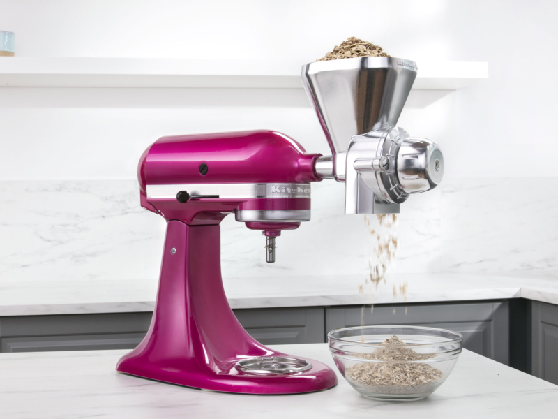 Pink KitchenAid® stand mixer with the All Metal Grain Mill Attachment grinding food