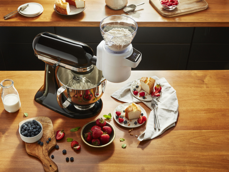 Black KitchenAid® stand mixer with the Sifter + Scale Attachment full of flour