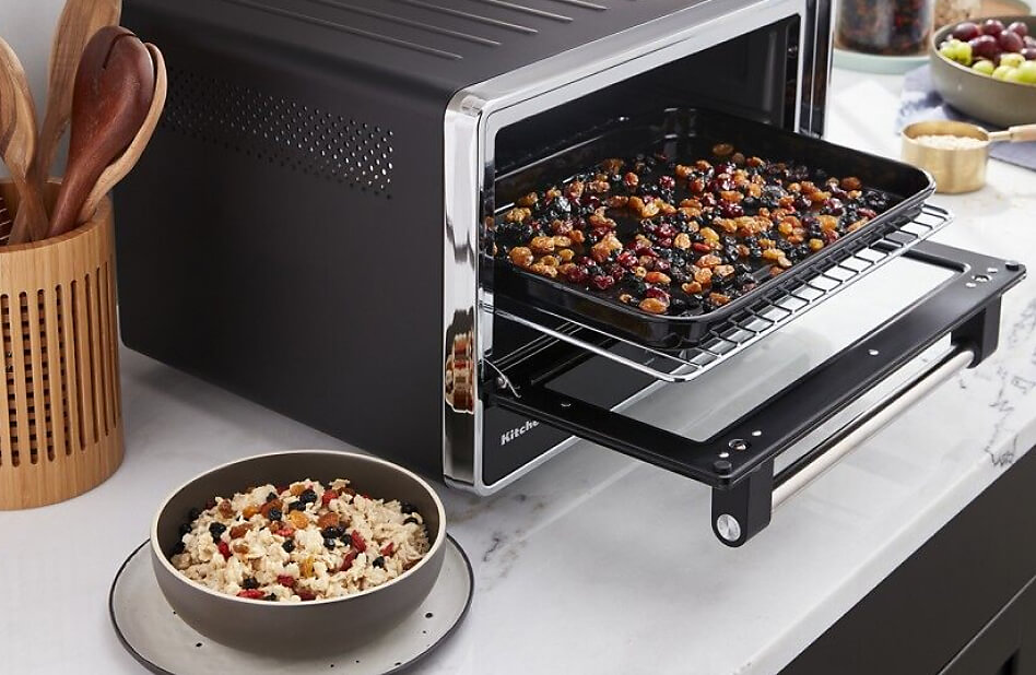 KitchenAid® countertop oven with air fryer filled with dried fruit