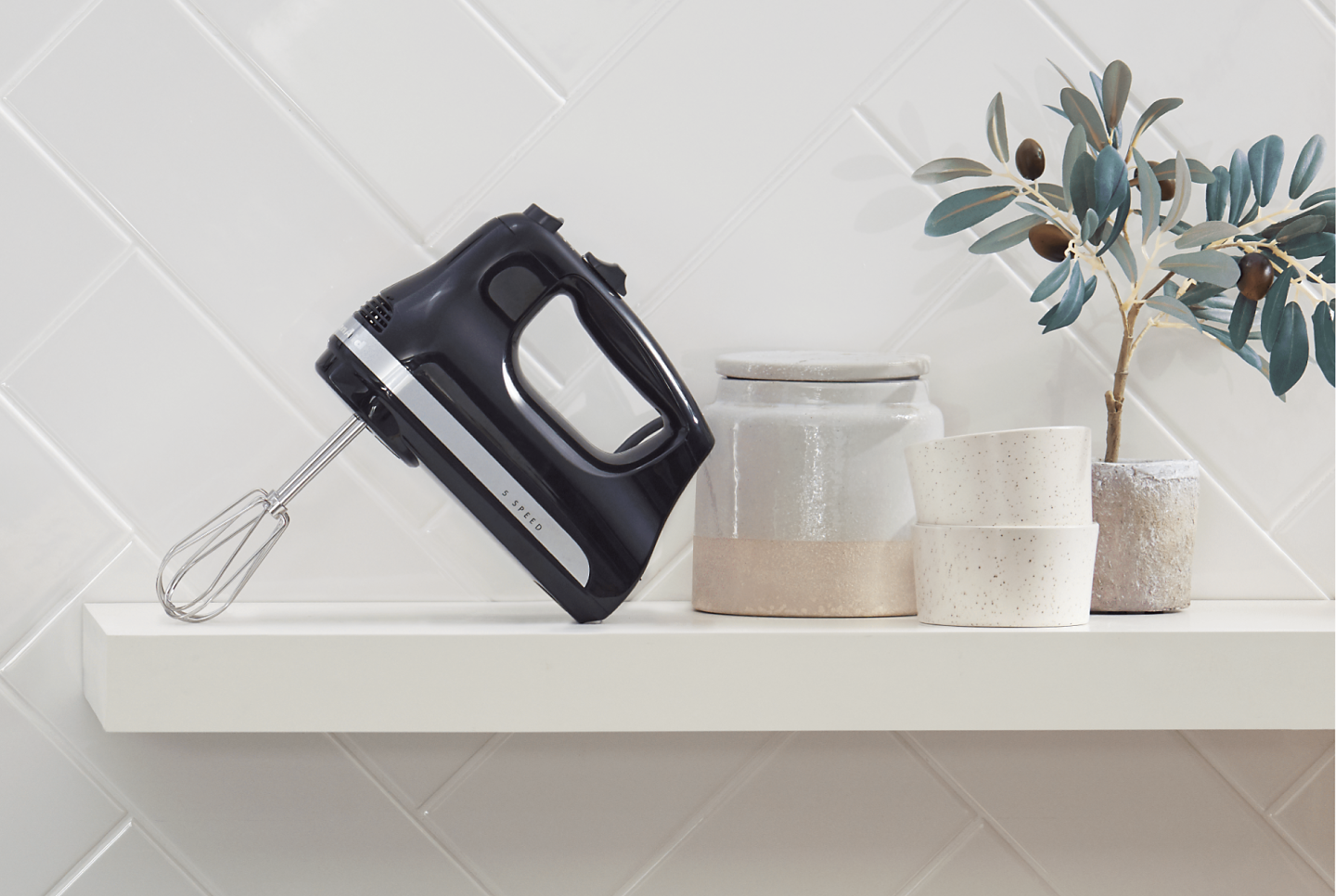  Black hand mixer next to ingredients and bowls on countertop