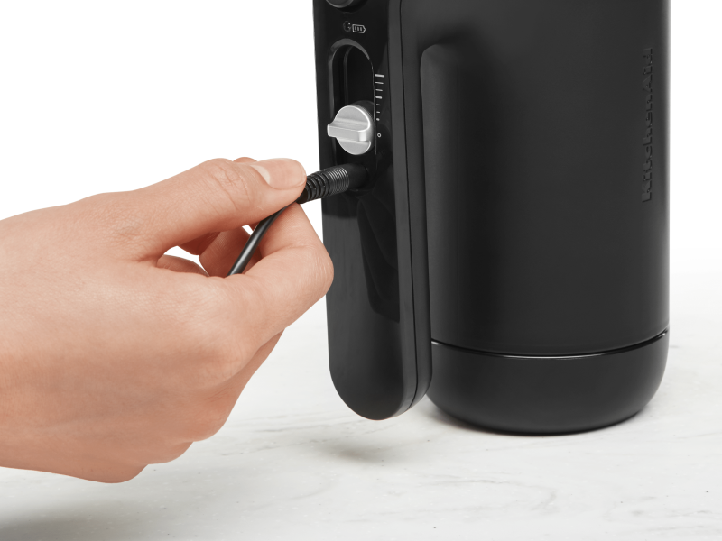Maker plugging cord into black KitchenAid® hand mixer
