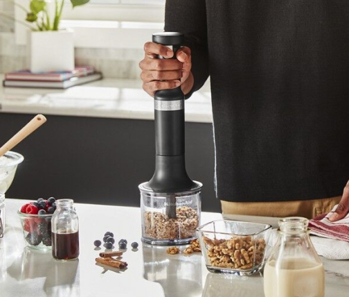 Man chopping nuts with hand blender chopper attachment