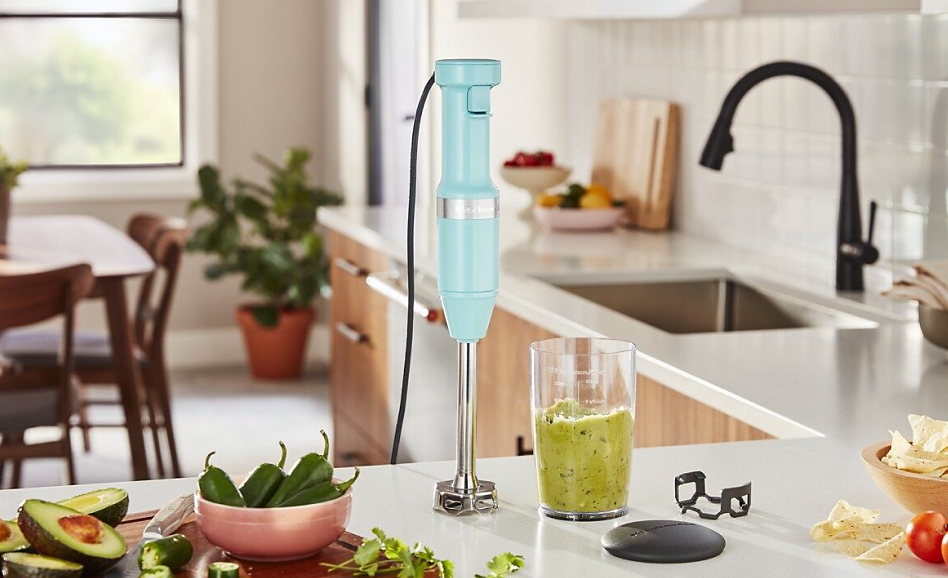 Ice blue KitchenAid® Variable Speed Corded Hand Blender on countertop with guacamole