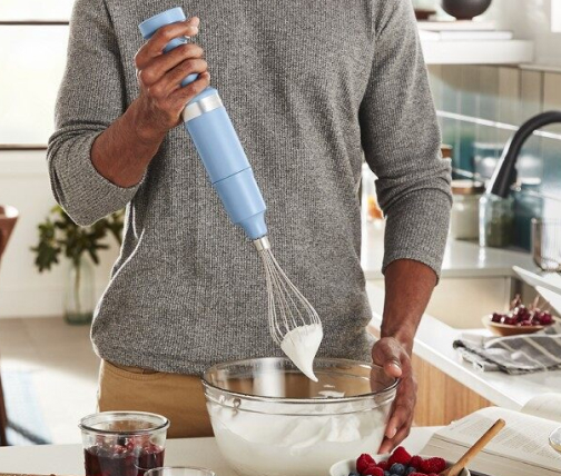  Man whipping cream with immersion blender
