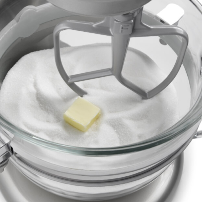 A stand mixer with butter and sugar