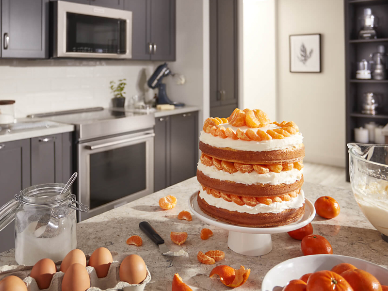 A layered cake with tangerines and cream