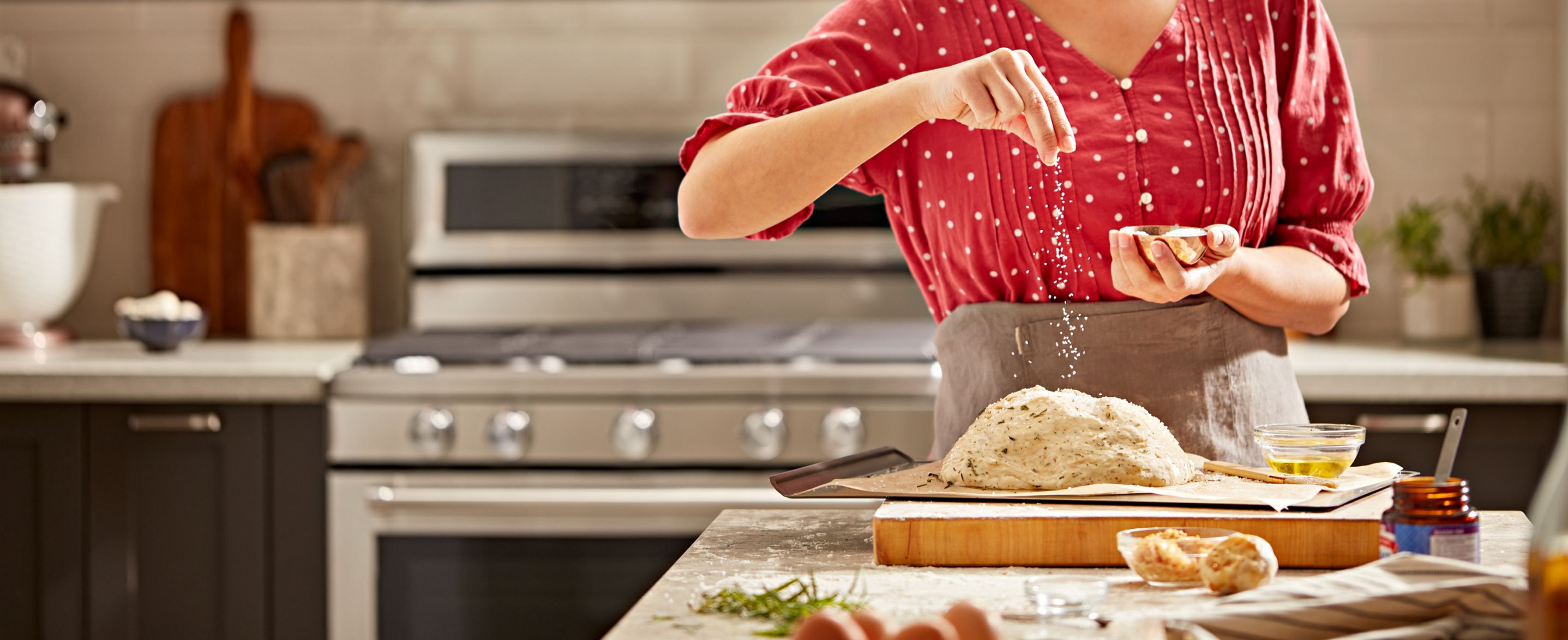 A woman preparing dough for homemade bread