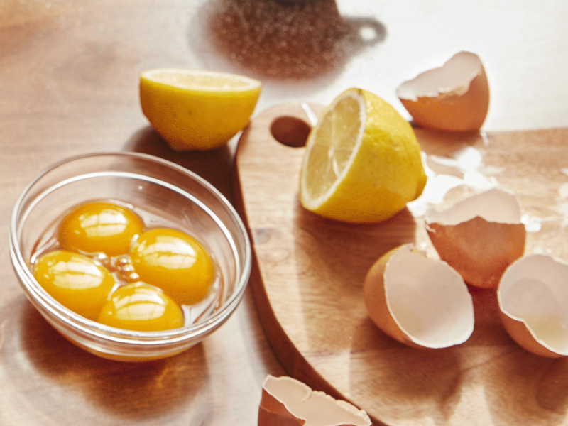 Lemon halves and cracked eggs