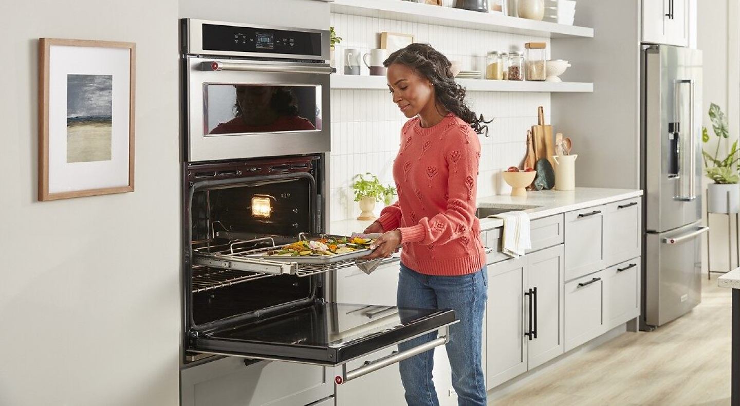 Person removing food from an oven