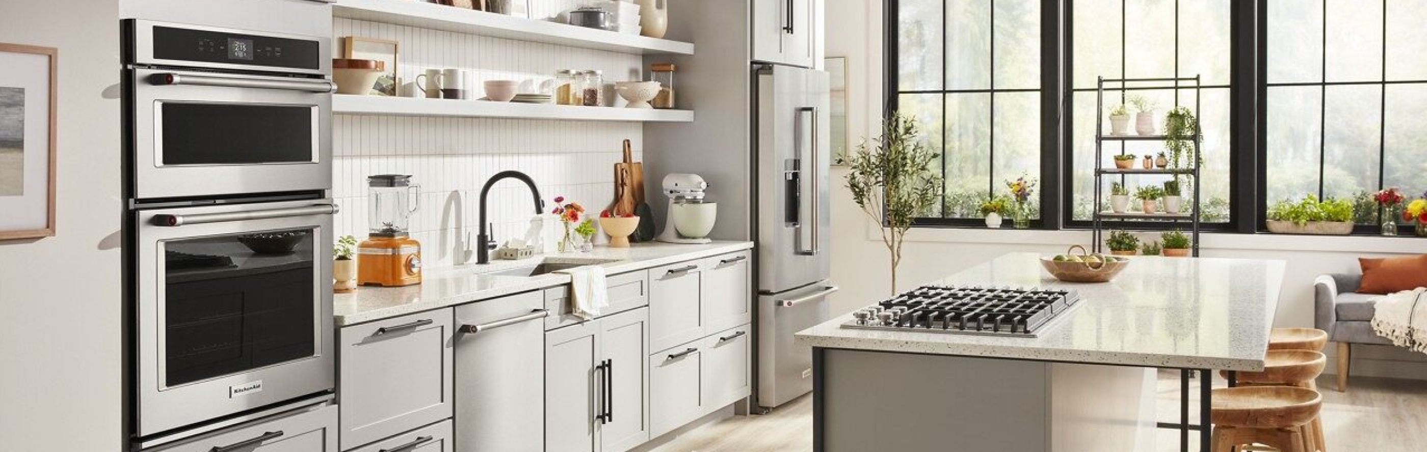 White bright kitchen with a suite of KitchenAid® stainless steel appliances 
