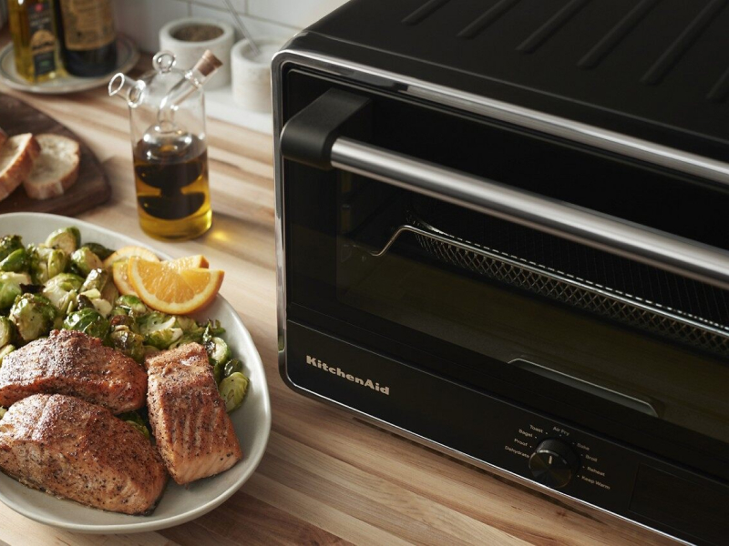 KitchenAid® countertop oven and tray of salmon and Brussels sprouts